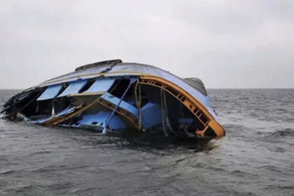 An overturned boat floating in the water,