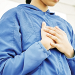 woman holding chest