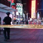 police official securing times square, crime scene