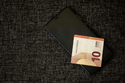 ten euros on top of a mobile phone