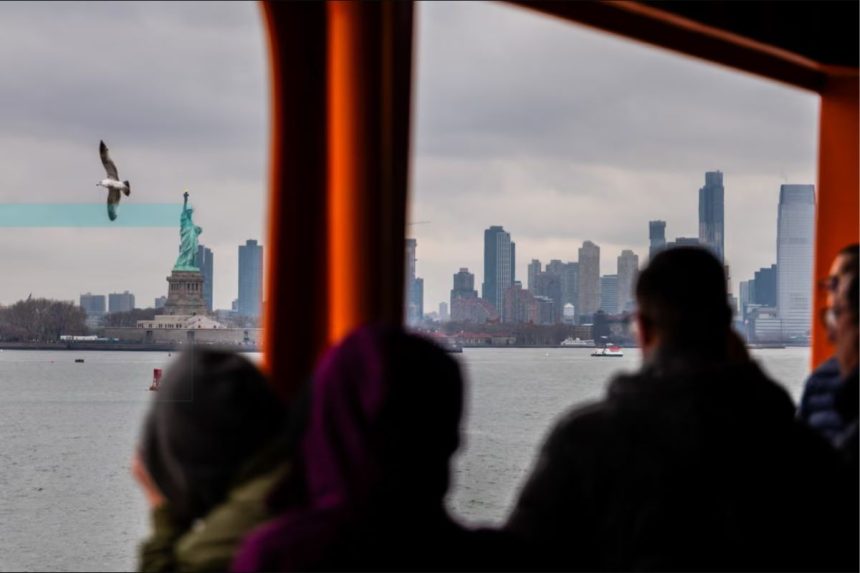 Tourists, business visitors ride the Staten Island Ferry in New York