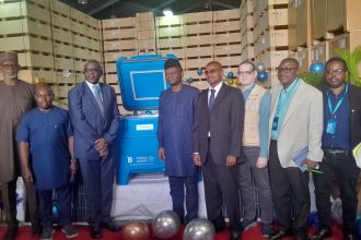 Executive Director of NPHCDA, Dr. Muyi Aina recieves solar-powered refrigerators,