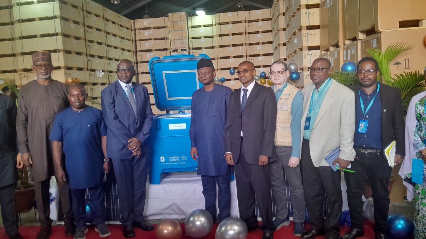 Executive Director of NPHCDA, Dr. Muyi Aina recieves solar-powered refrigerators,