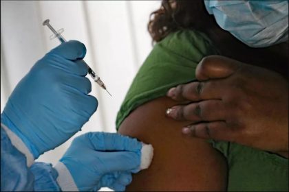 specialist vaccinating patients, High risk groups, such as babies and old people, are being urged to get vaccinated