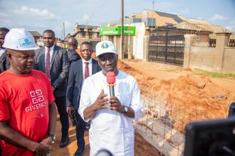 Governor Okpebholo holding microphone
