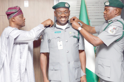 Wale Edun and the Comptroller-General of Customs, Bashir Adewale Adeniyi decorates Babatunde Olomu with new rank of Assistant Comptroller-General of Customs recently in Abuja