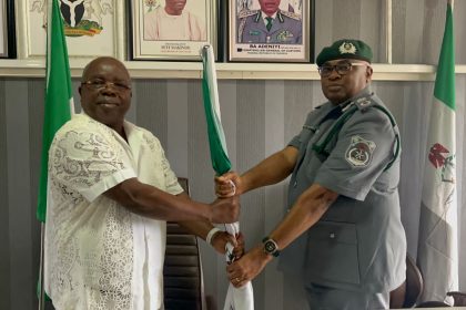 New Oyo/Osun Controller, Comptroller, Gambo Iyere Aliyu, and outgoing Comptroller Joseph Olugbuyi Adelaja holding a staff