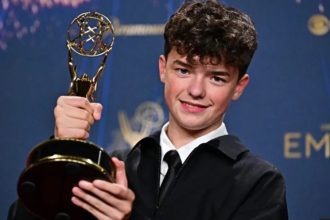 Owen Cooper receiving Emmy's award