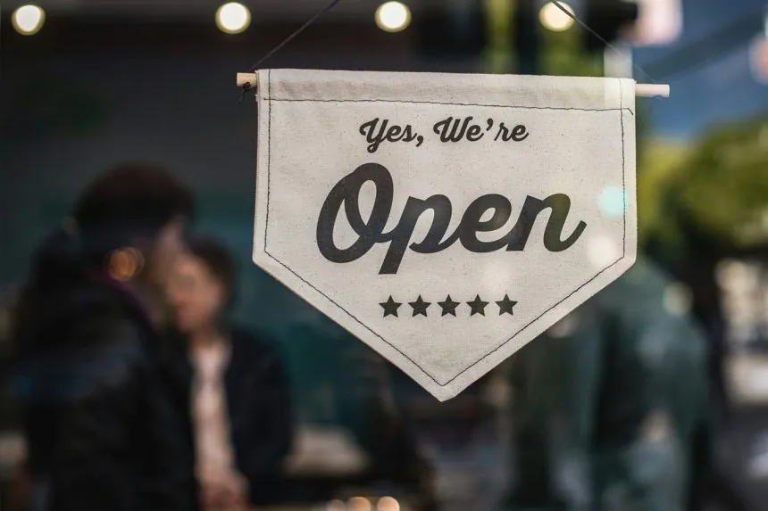 We are open sign in front of a business