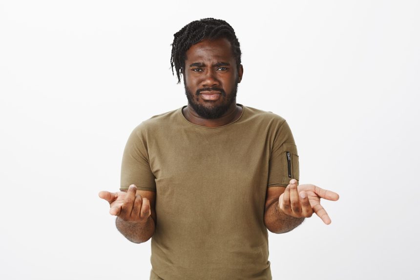 Are you kidding me. Frustrated doubtful plump african-american man with beard, pointing with index fingers at camera, frowning and feeling intense, being unsure and questioned over gray wall