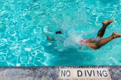 person diving into the swimming pool