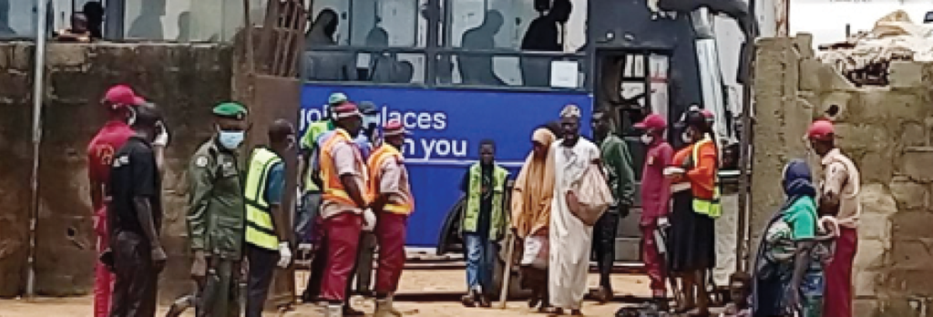 The destitute disembarking from the bus which conveyed them to the Resettlement Centre