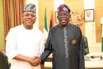 Gov Ododo shaking hands with Tinubu