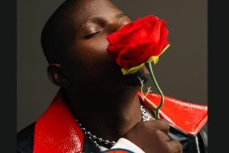 Singer XKOLIE holding rose flower