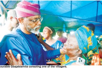 Honourable Gbajabiamila consoling one of the villagers Oriire Local Government Area