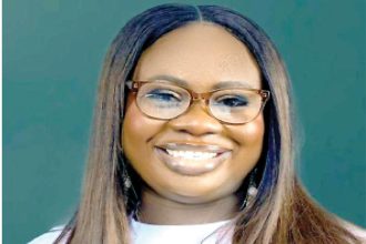 Precious Osode smiling Nigerian food in UK