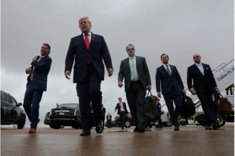 US President Donald Trump walks with Representative Pat Fallon (R-TX), as he arrives at Dallas Fort Worth International Airport, in Dallas, Texas, US
