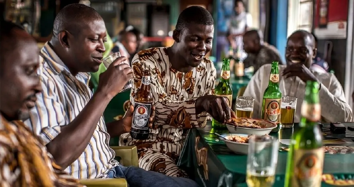 People, presumed to be from the Ghana Drunkards Association, drinking beer,