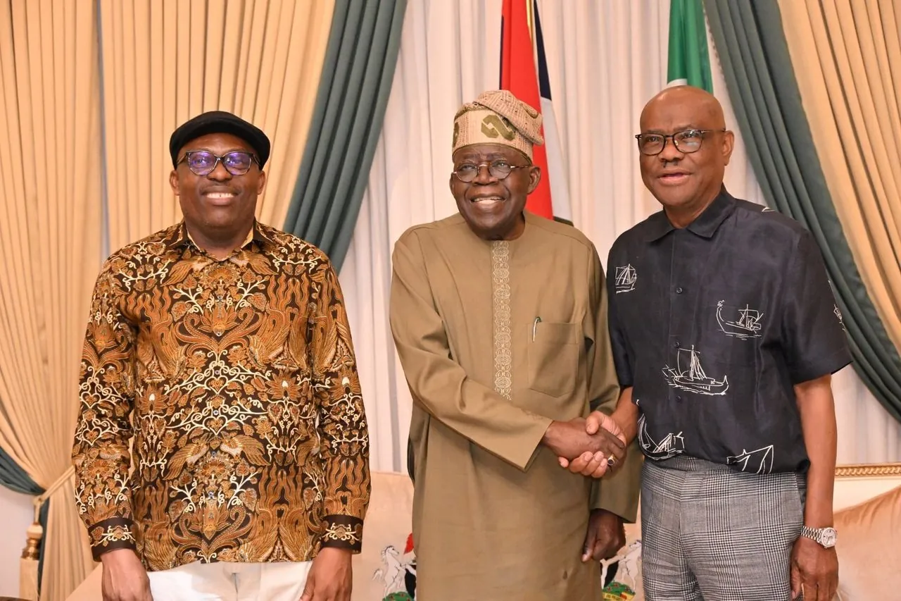 Presidemt Bola Tinubu, FCT Minister Nyesom Wike, and Rivers governor Sim Fubara smiling